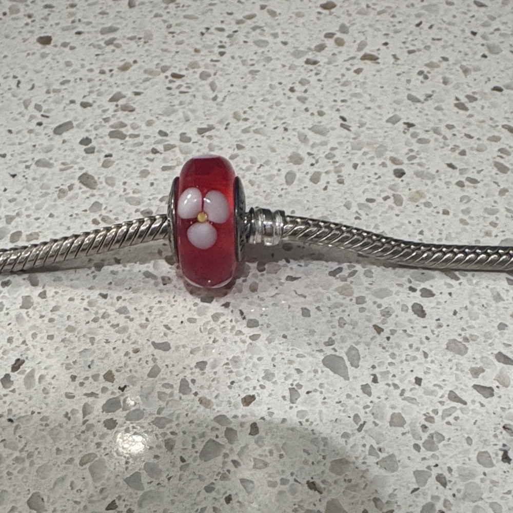 Pandora red bead with a flower design